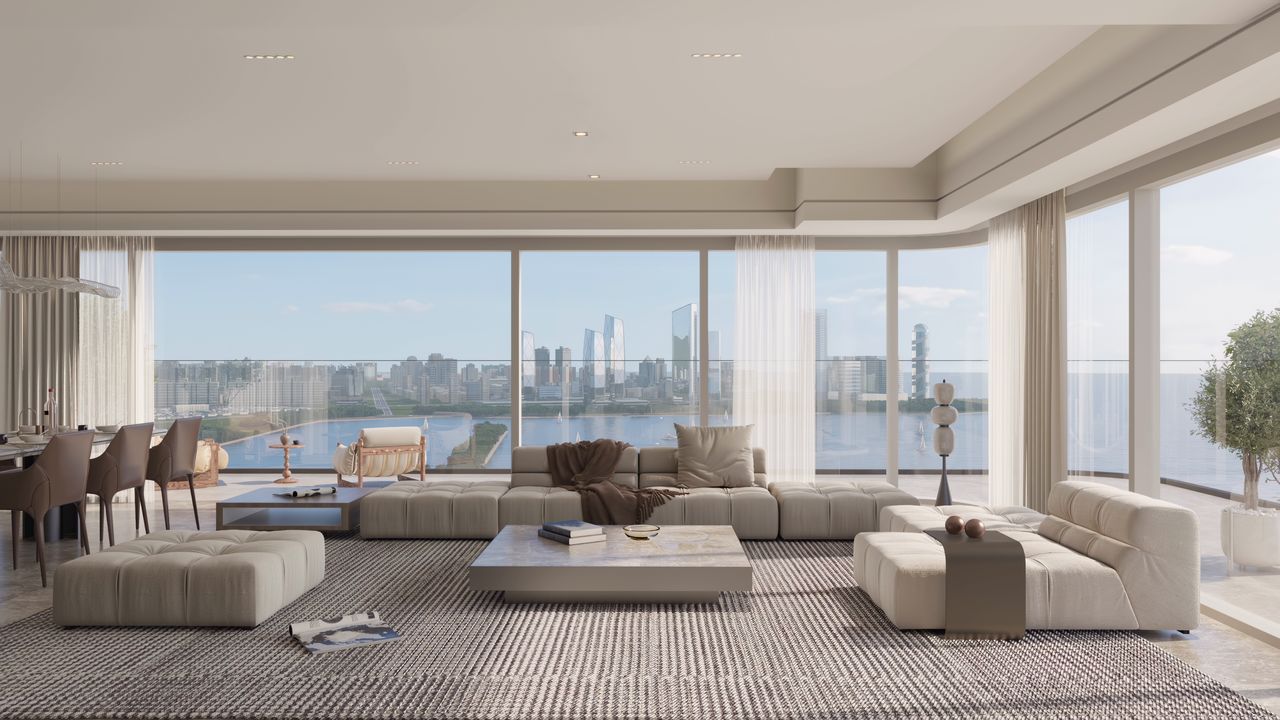 Living and dining room with full-height windows and a view across the water.