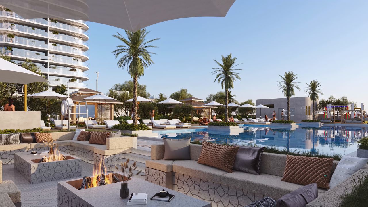 Outdoor lounge with a fire pit beside the pool